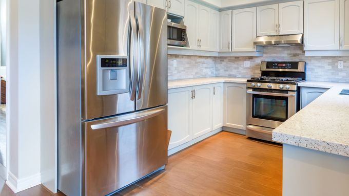 Kitchen with as stainless steel refrigerator.