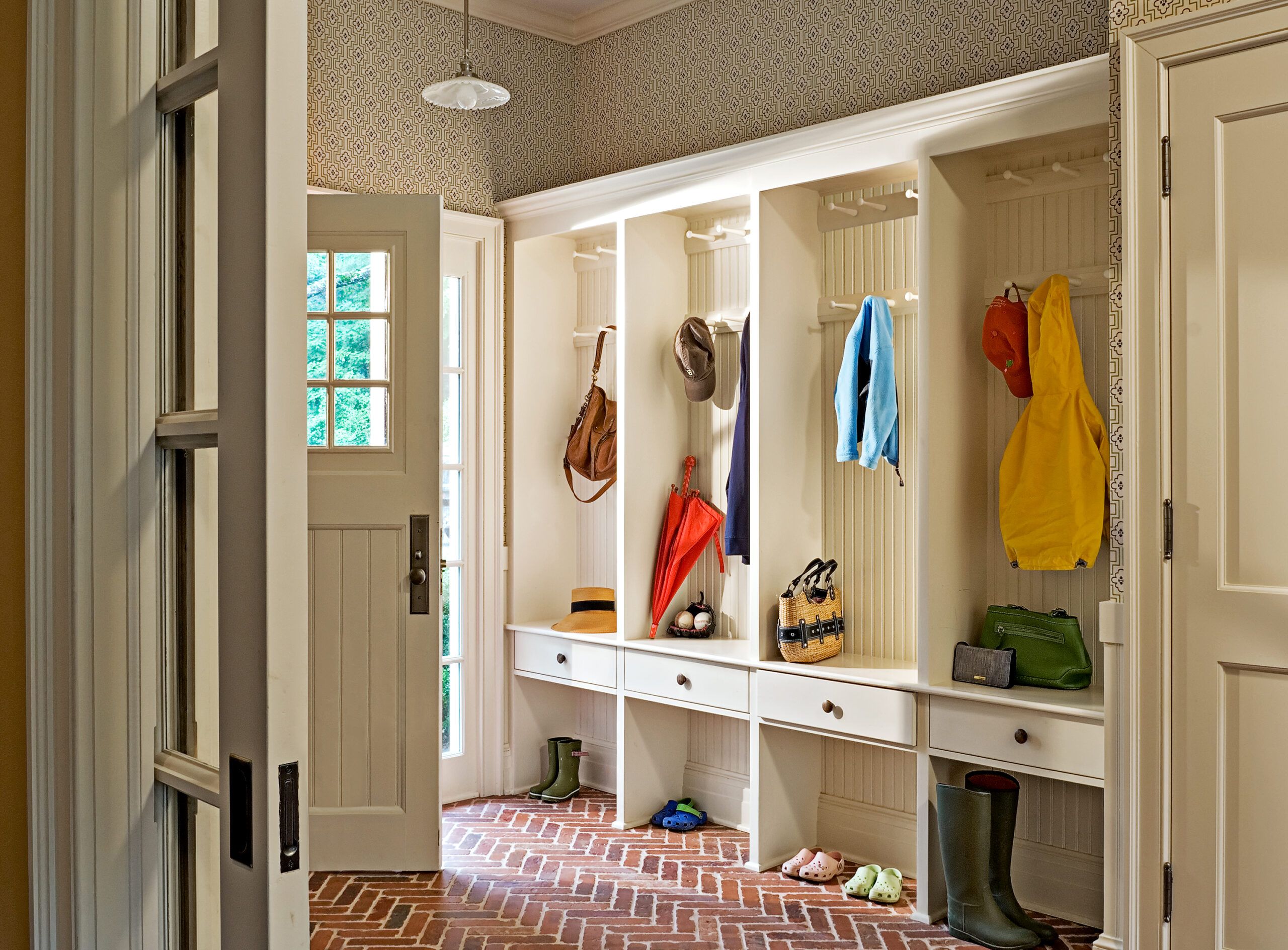 A mudroom with built-in places to hag bags and coats.