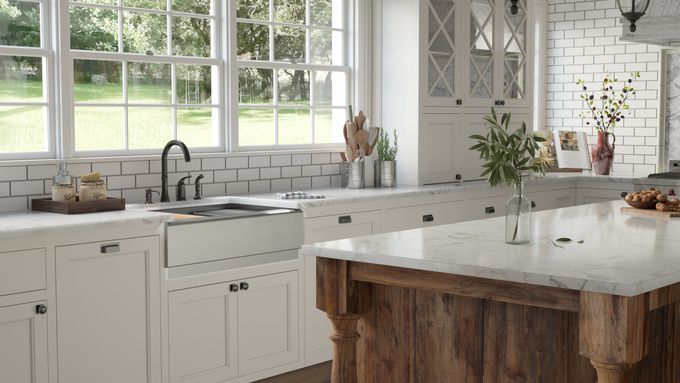 A sink set into a marble counter in a kitchen.