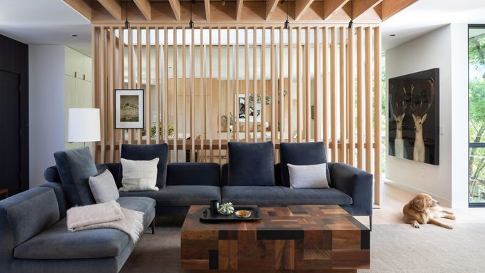 A room with a wooden slat room divider.