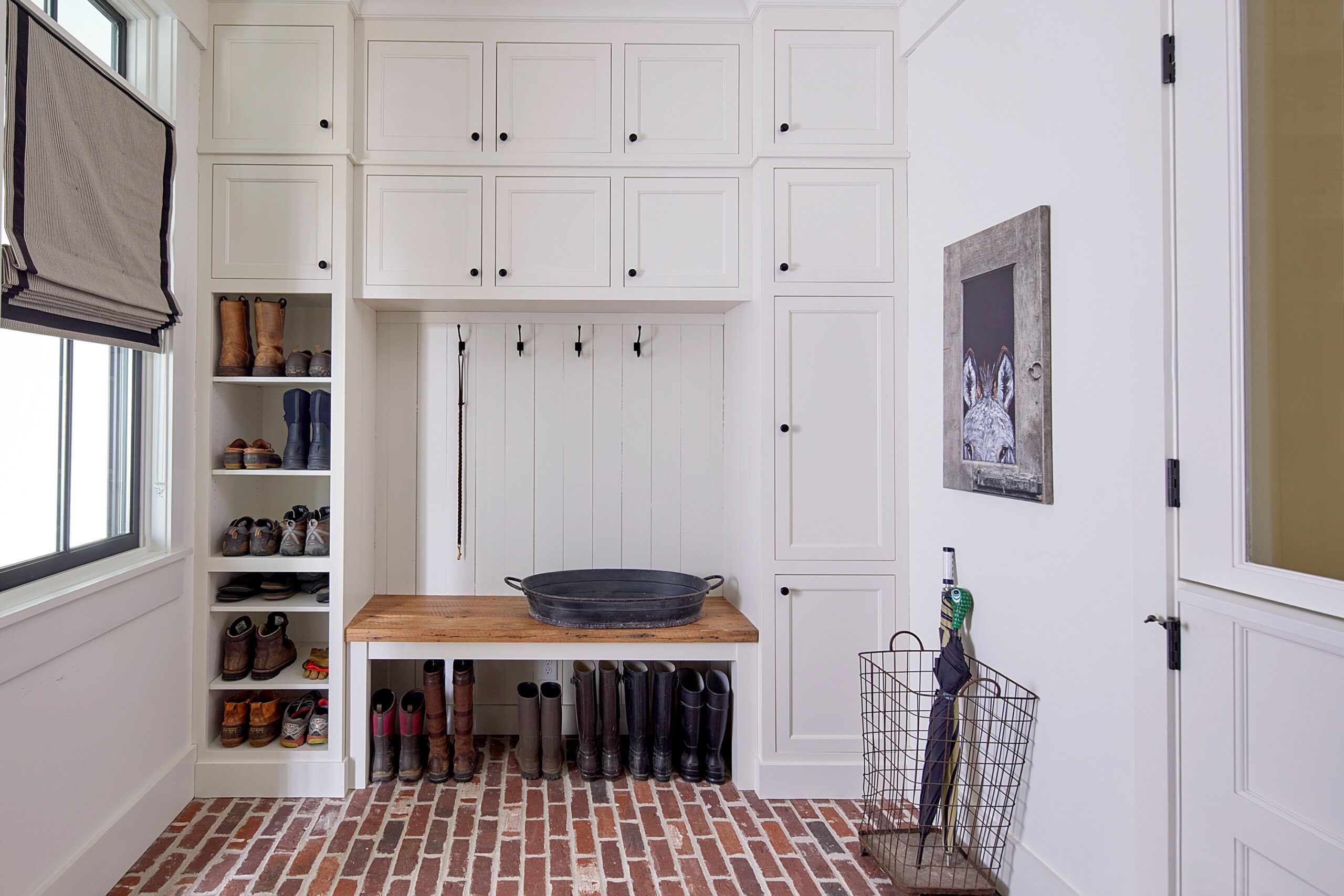 A mudroom including a basket for umbrella storage.