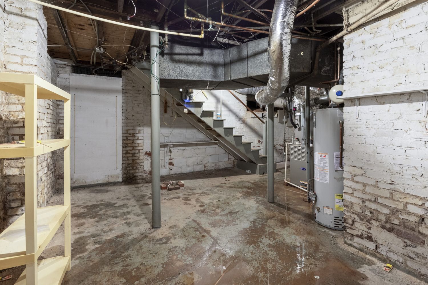 Stairs descending into a wet basement that needs to be dried out.