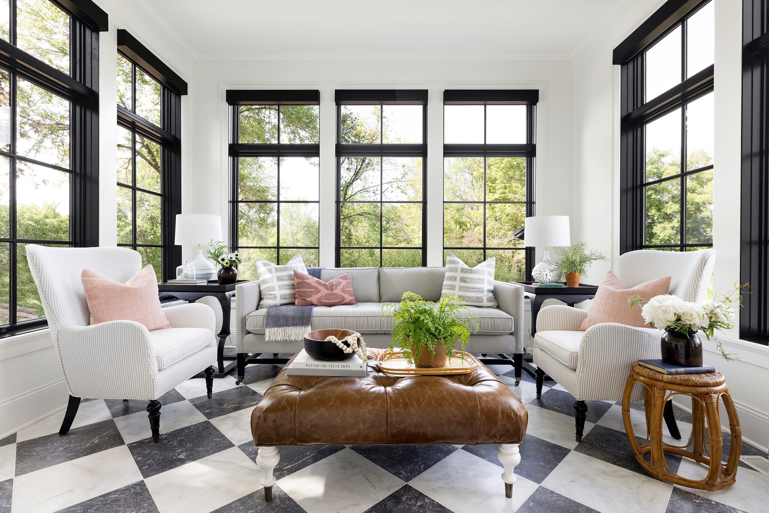 Image of a sunroom that is great for conversations, filled with multiple seating options and decorative tiled floor