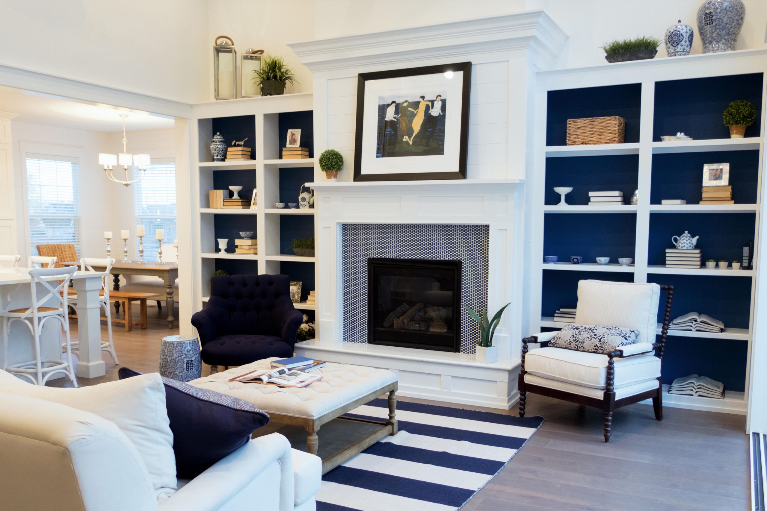 A decluttered sitting room with artwork over the fireplace.