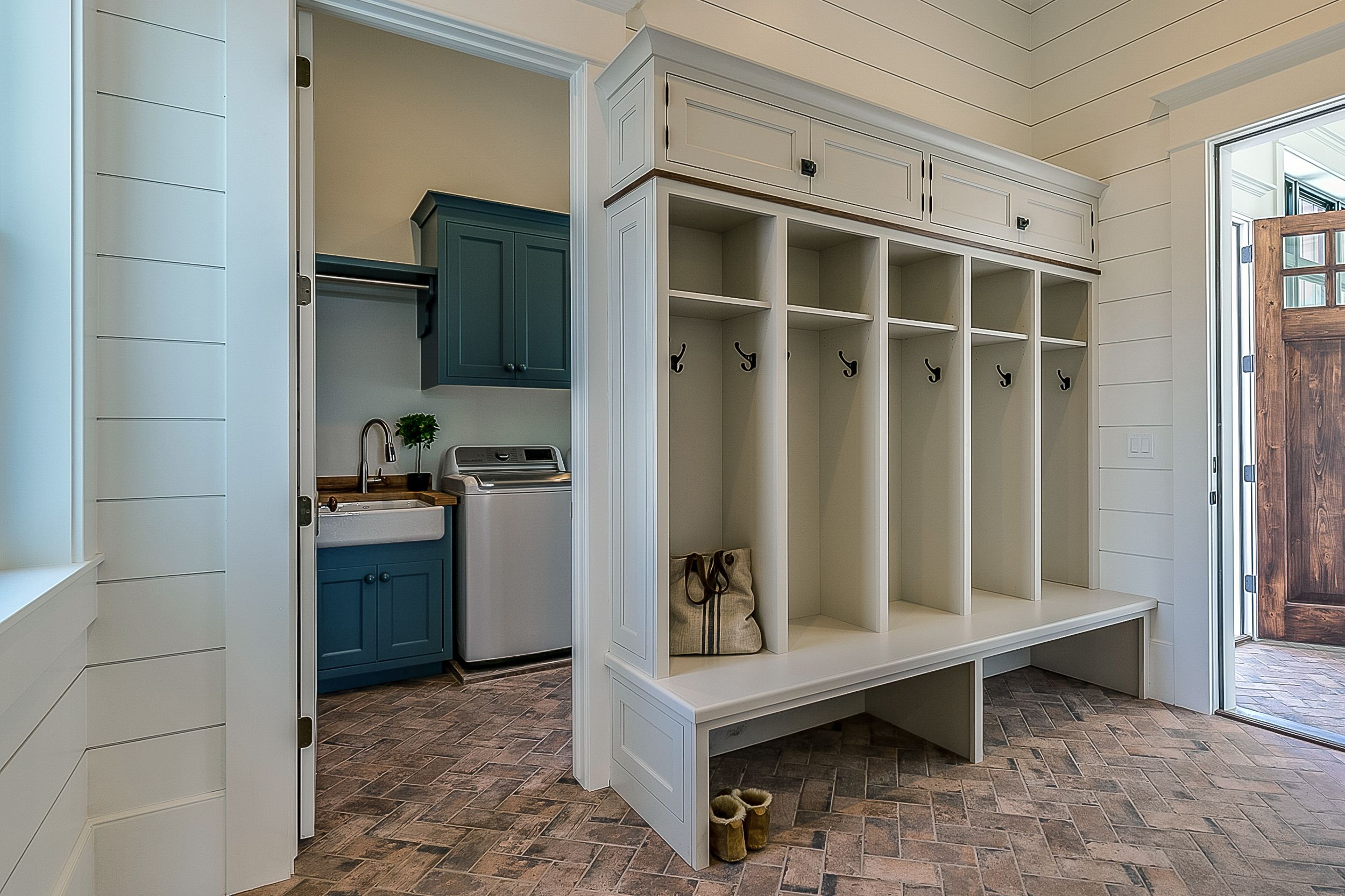 A mudroom with a connecting laundry room.