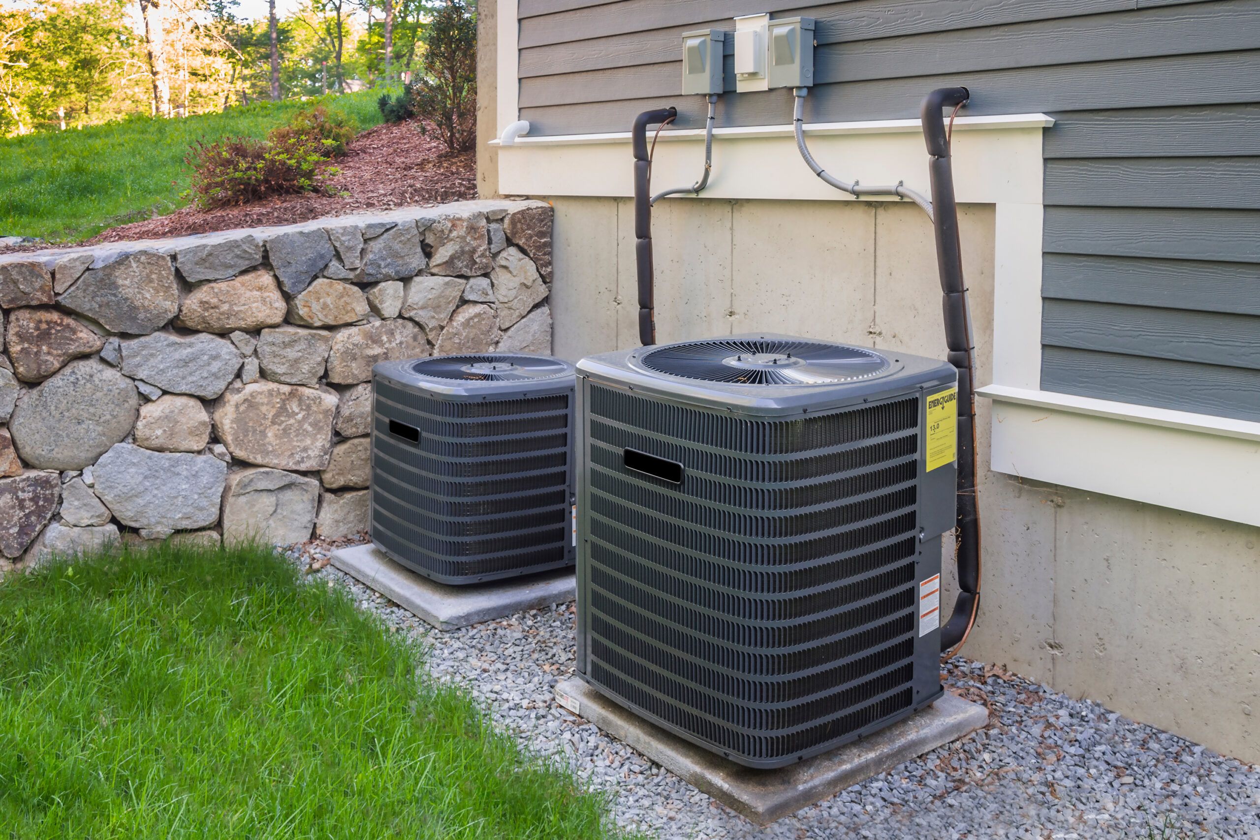 Central air conditioning system attached to the side of a home