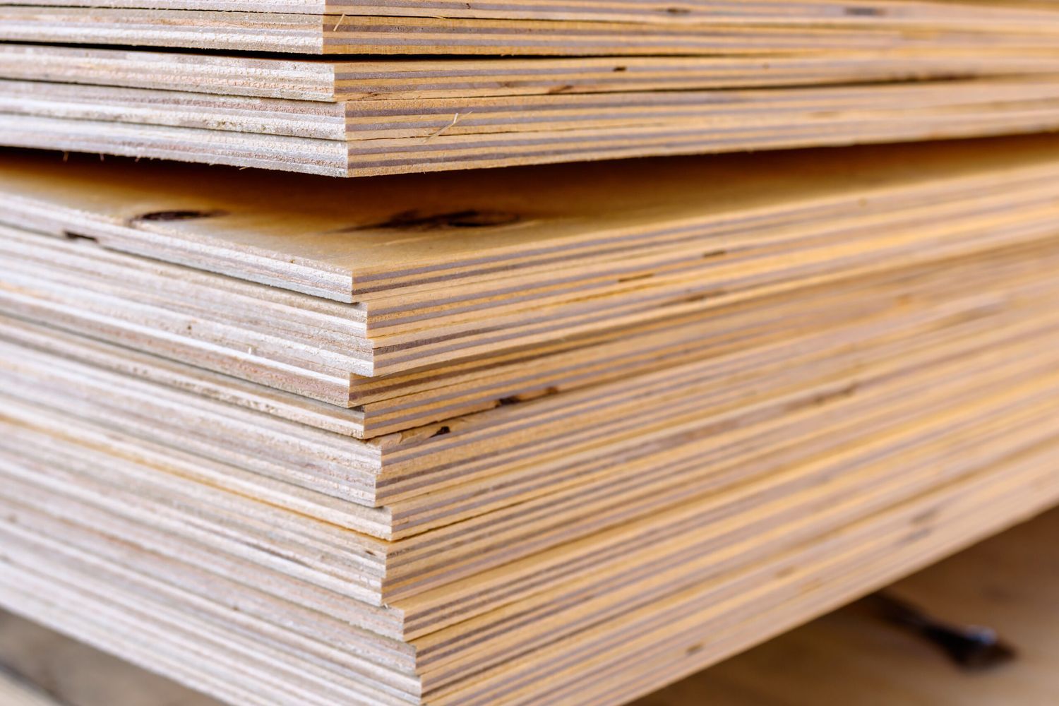 A tall stack of plywood boards.