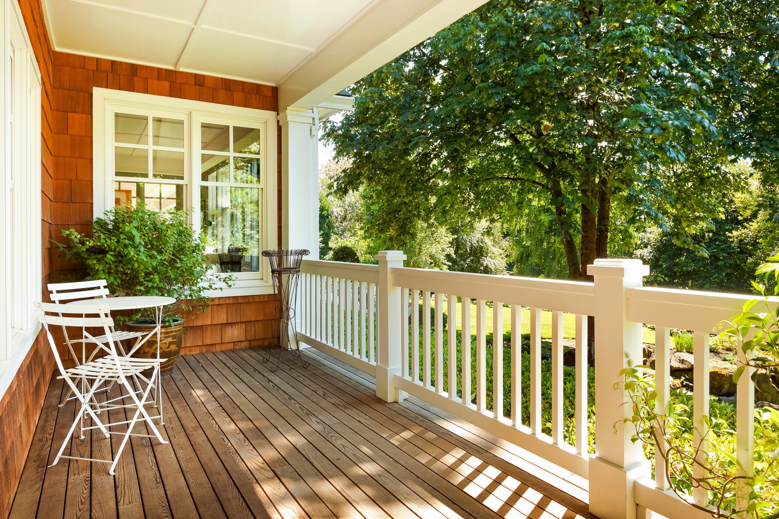 A covered back patio with late summer sun shining in.