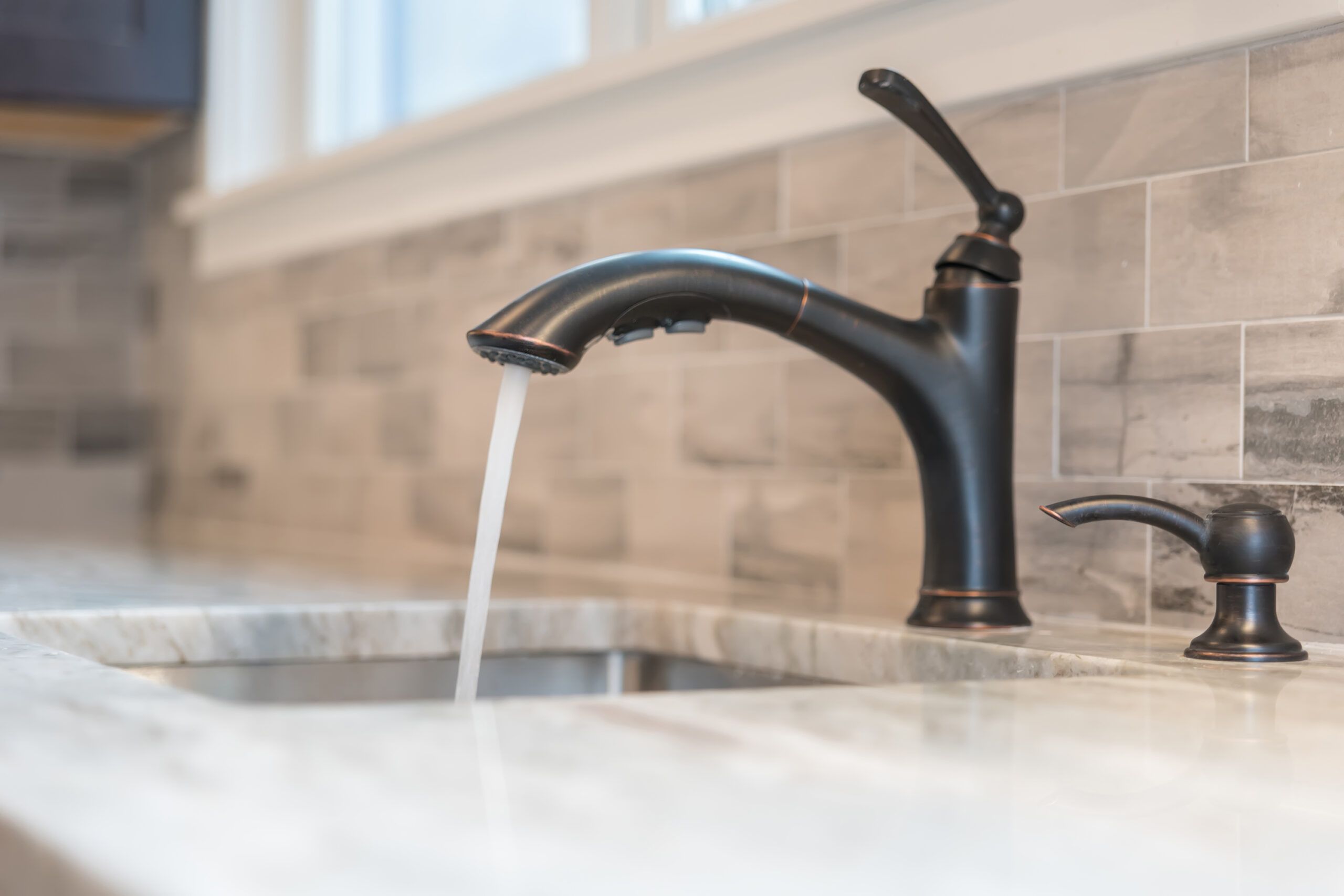 An image of a running water faucet.