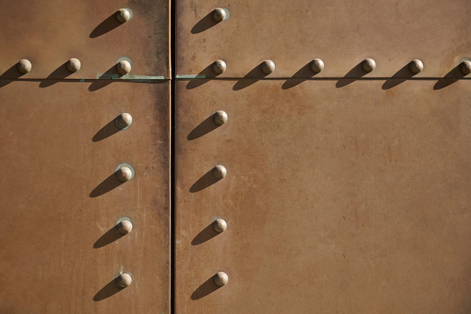 A set of rivets in a wall to be removed.