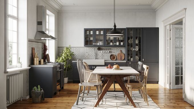 A kitchen with hardwood flooring and large windows.