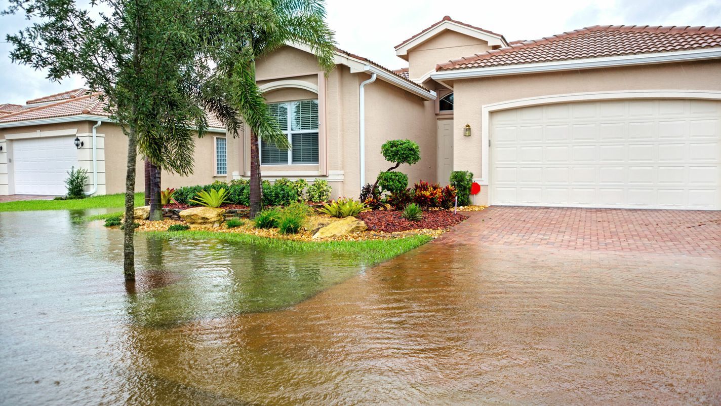 Photo of a flood encroaching on a home. Preparing for a flood can prevent your house from damage.