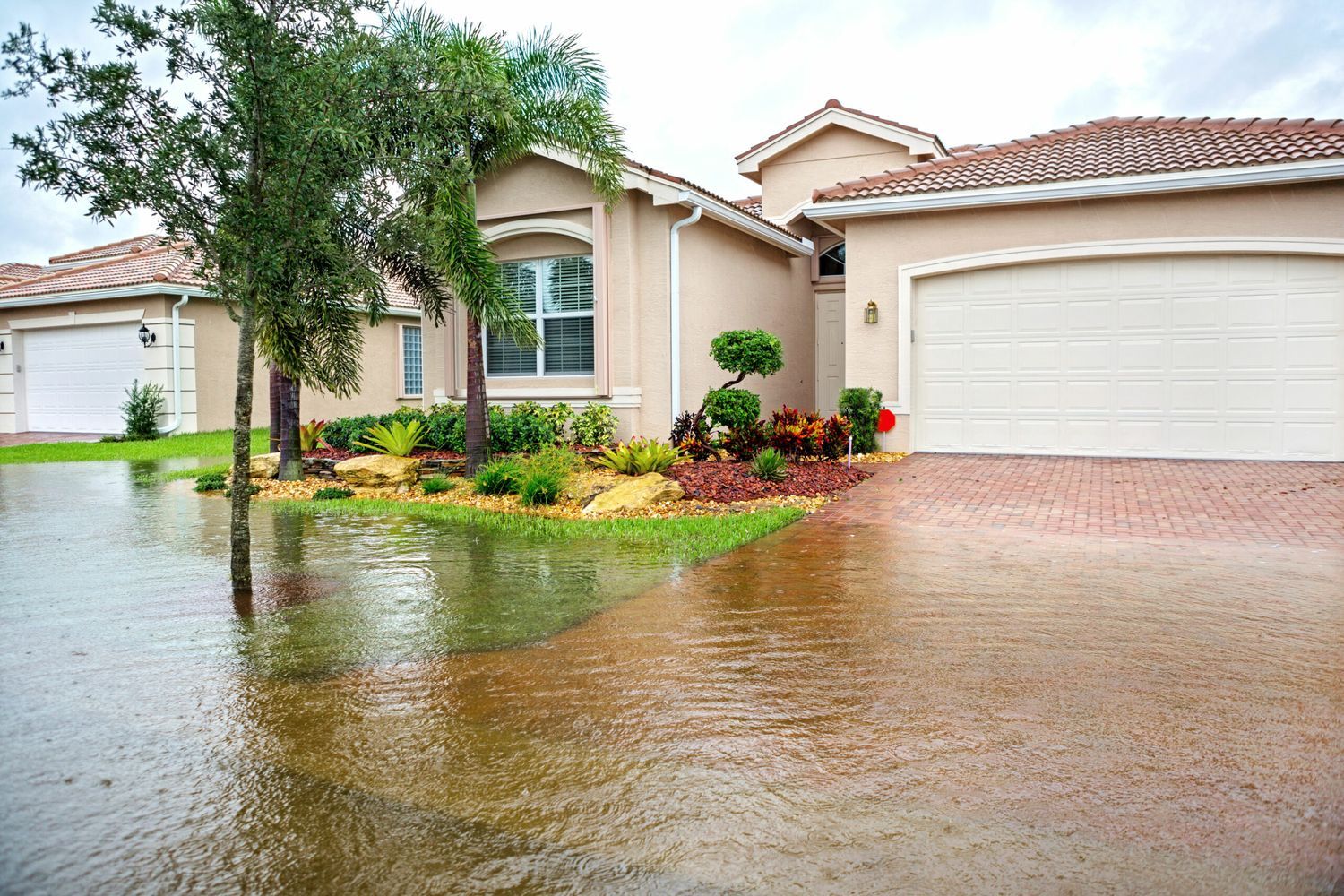 Photo of a flood encroaching on a home. Preparing for a flood can prevent your house from damage.