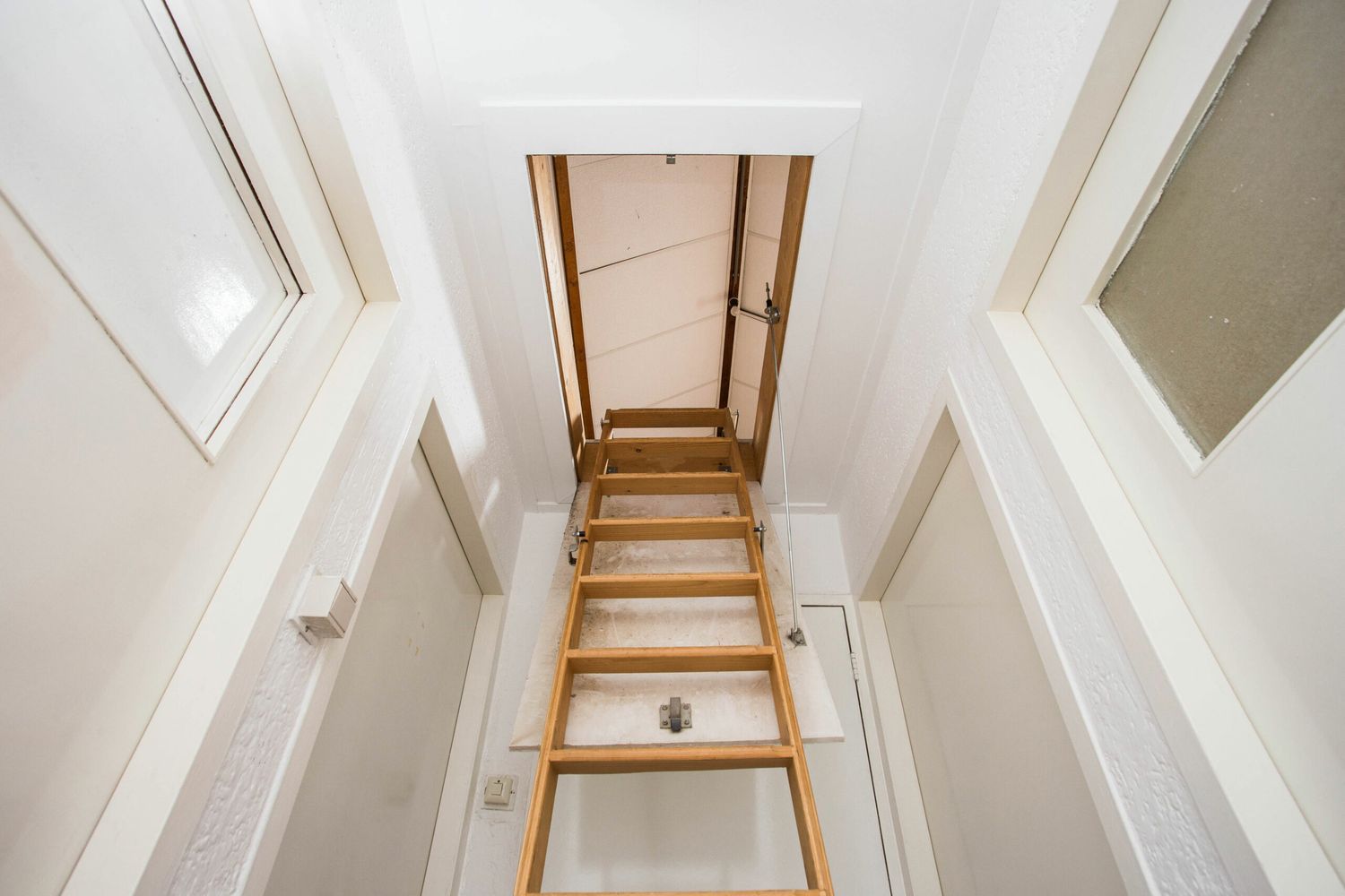 An insulated pull down steps style attic door.
