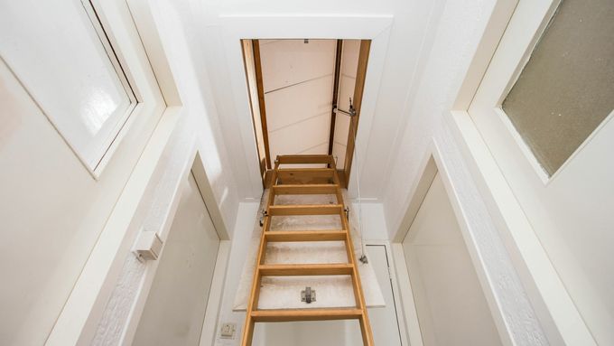 An insulated pull down steps style attic door.