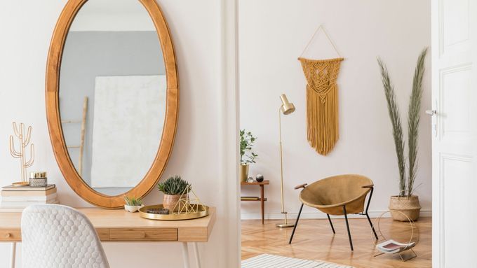 Glass mirror cut into an oval shape and set in a wooden frame.