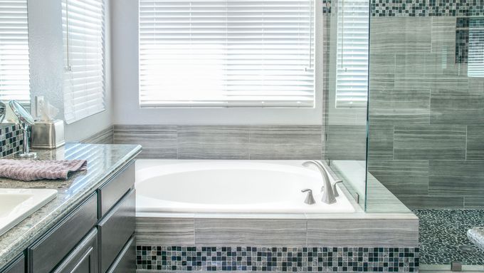 A bathtub that has been deep cleaned, it is white and spotless.