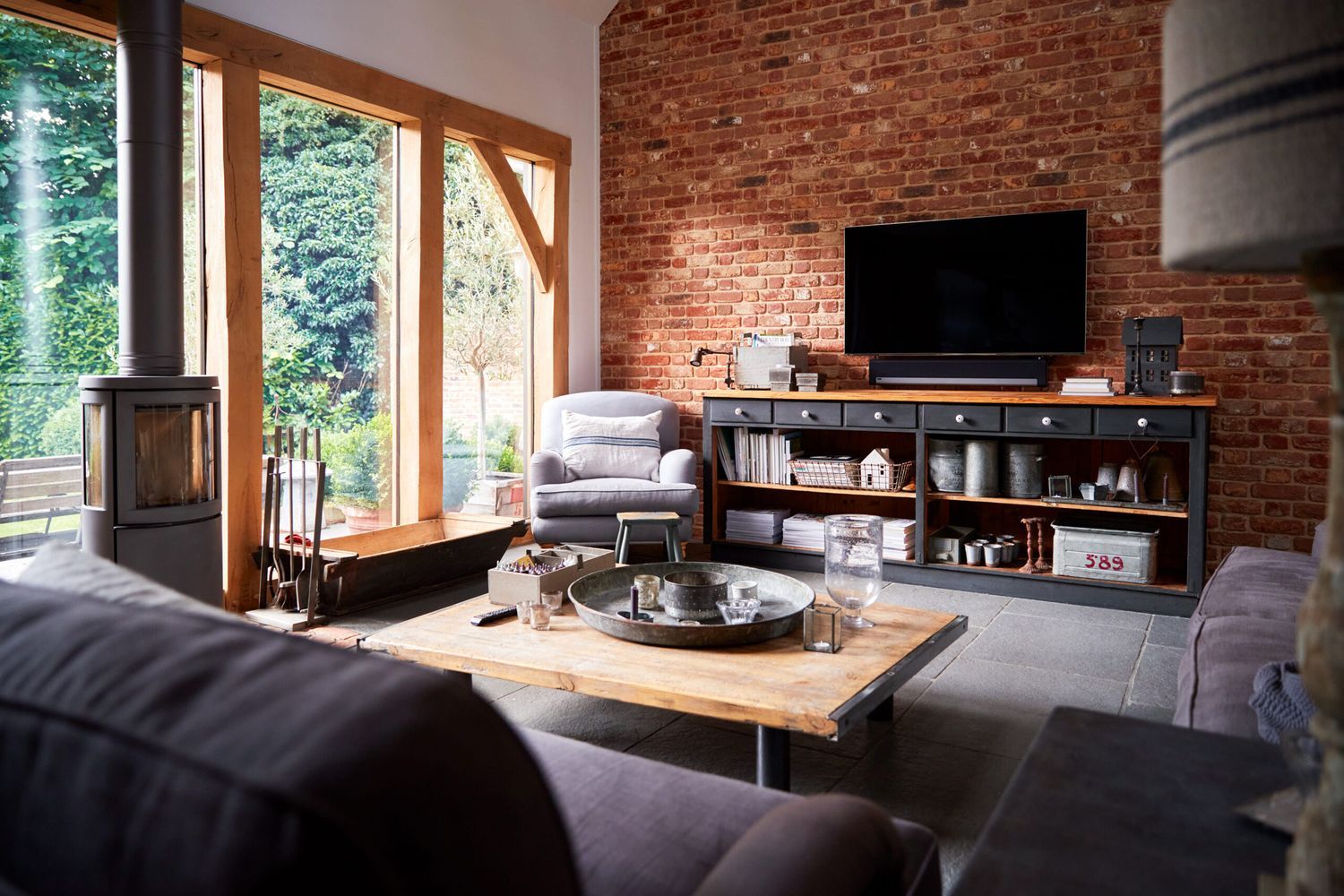 A living room TV mounted on brick