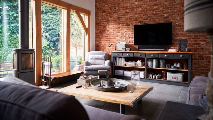 A living room TV mounted on brick