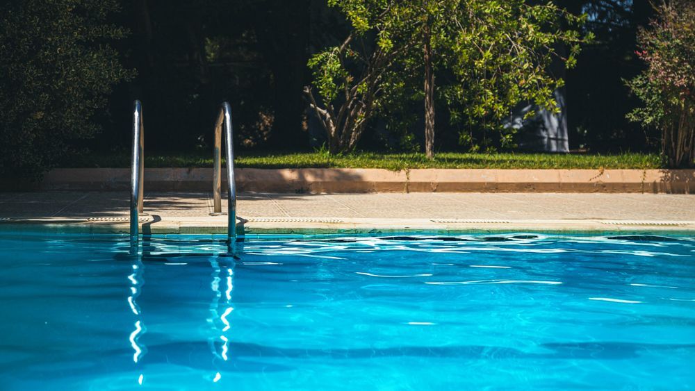 A pool filled with water to be drained.