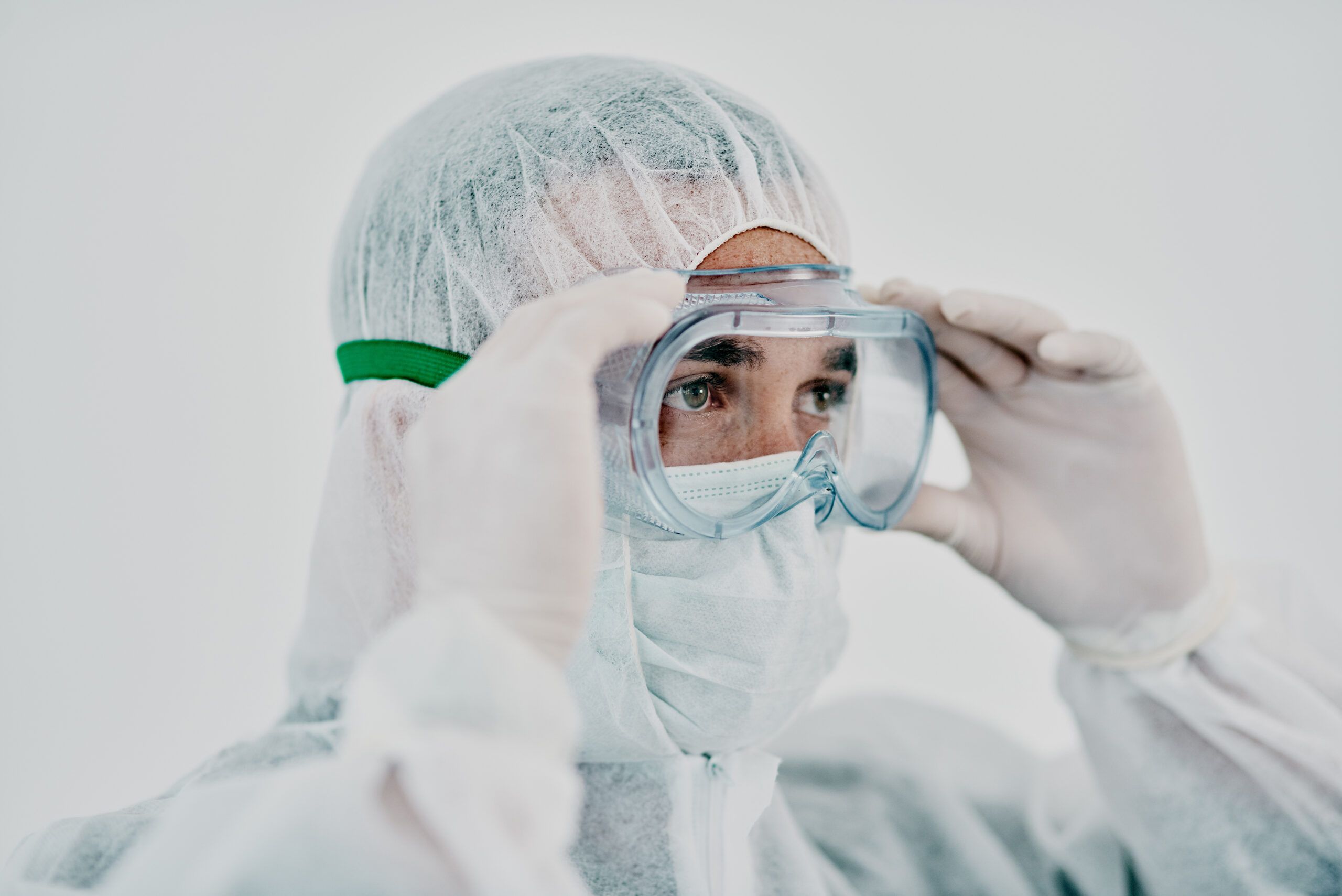 Image of a person wearing protective gear for cleaning up after a house fire