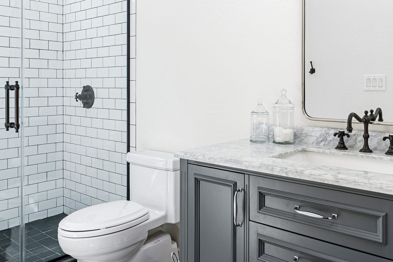 A Toilet sitting in a bathroom beside a sink and shower.