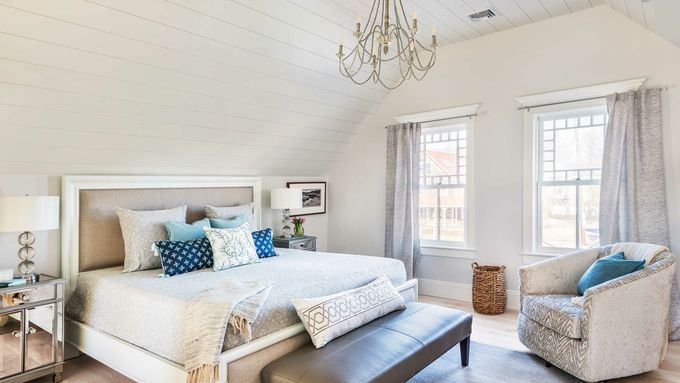 A bedroom with shiplap walls.