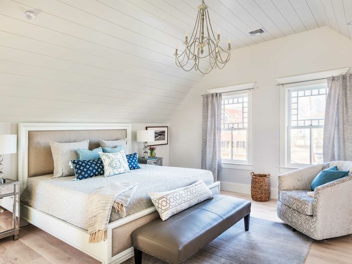 A bedroom with shiplap walls.