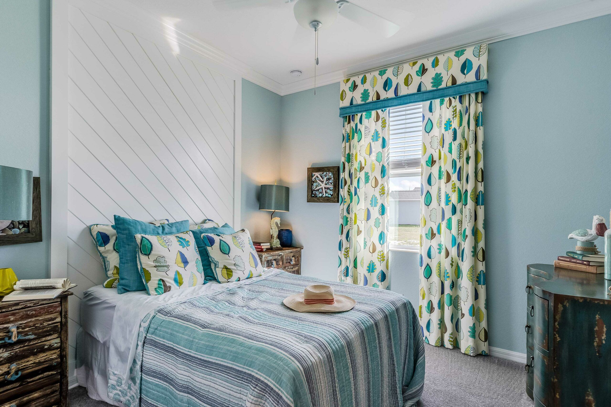 A bed in front of a diagonal shiplap wall.