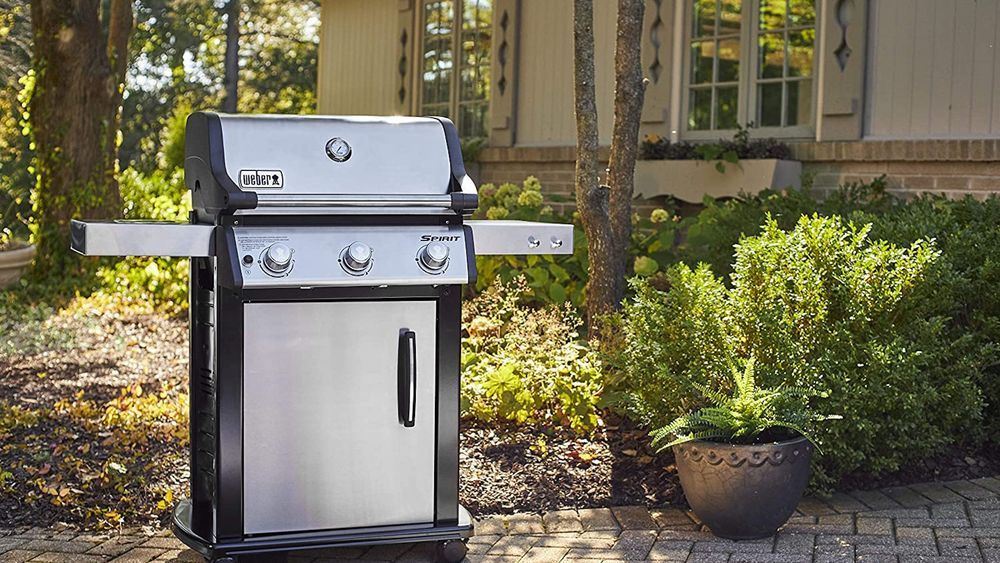 Best gas grill guide cover image, featuring a stainless-steel propane grill on a sunny brick patio.