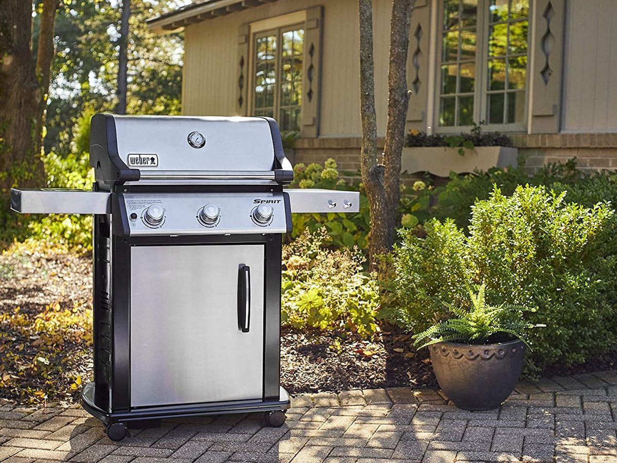 Best gas grill guide cover image, featuring a stainless-steel propane grill on a sunny brick patio.