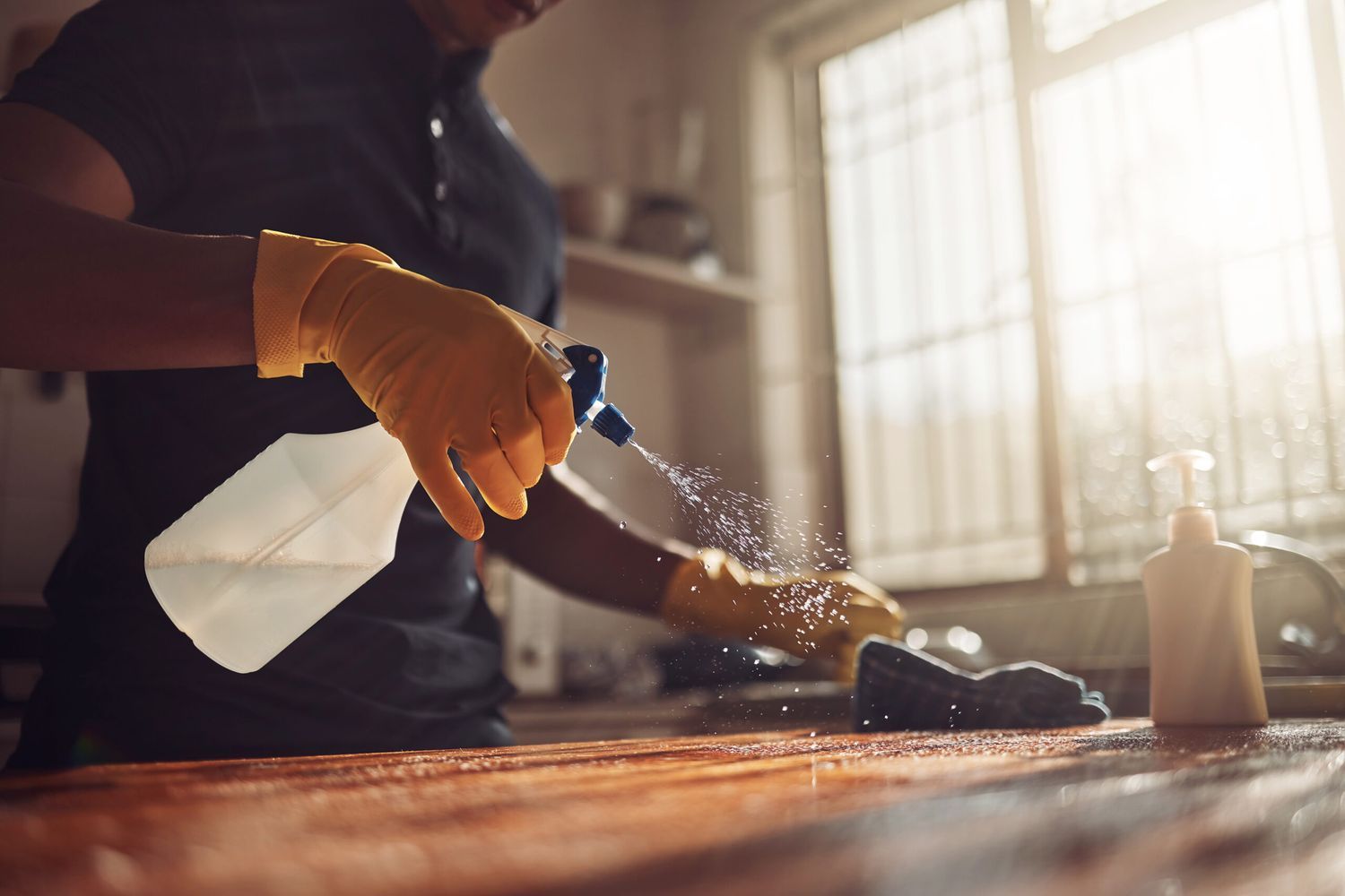 A person cleans a butcher block.
