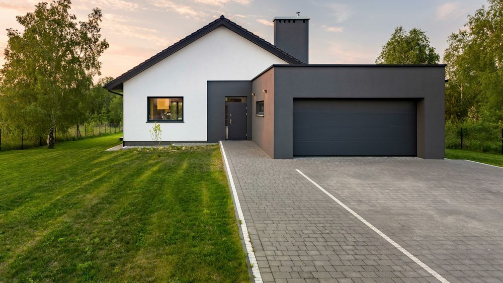 Modern-style home with newly replaced paver driveway.