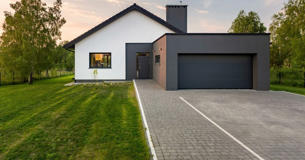 Modern-style home with newly replaced paver driveway.
