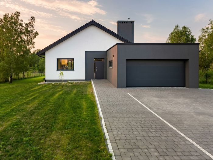 Modern-style home with newly replaced paver driveway.