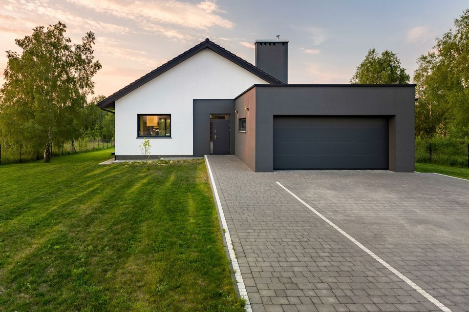 Modern-style home with newly replaced paver driveway.