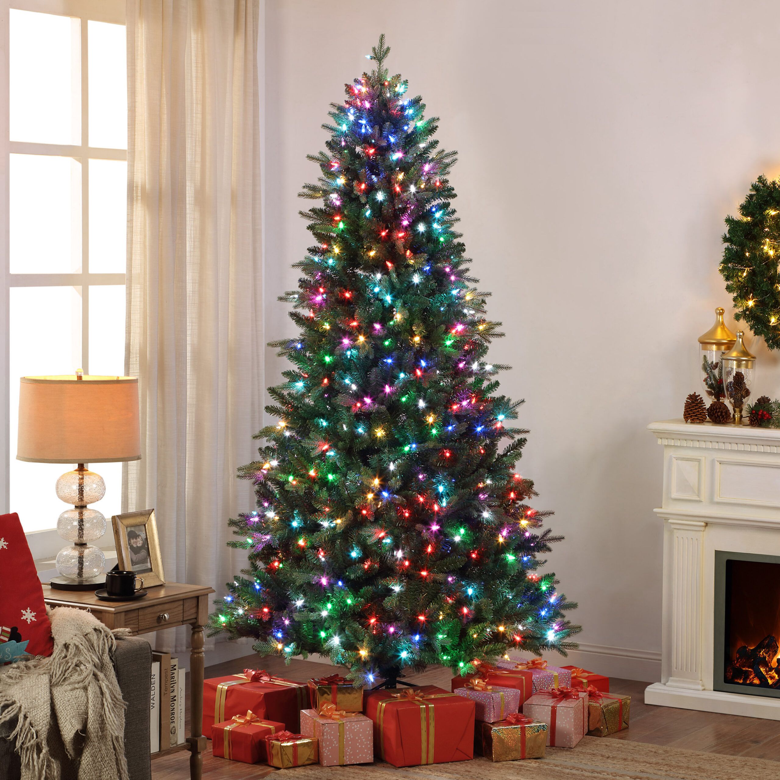 A lit up Christmas Tree sitting in a living room.