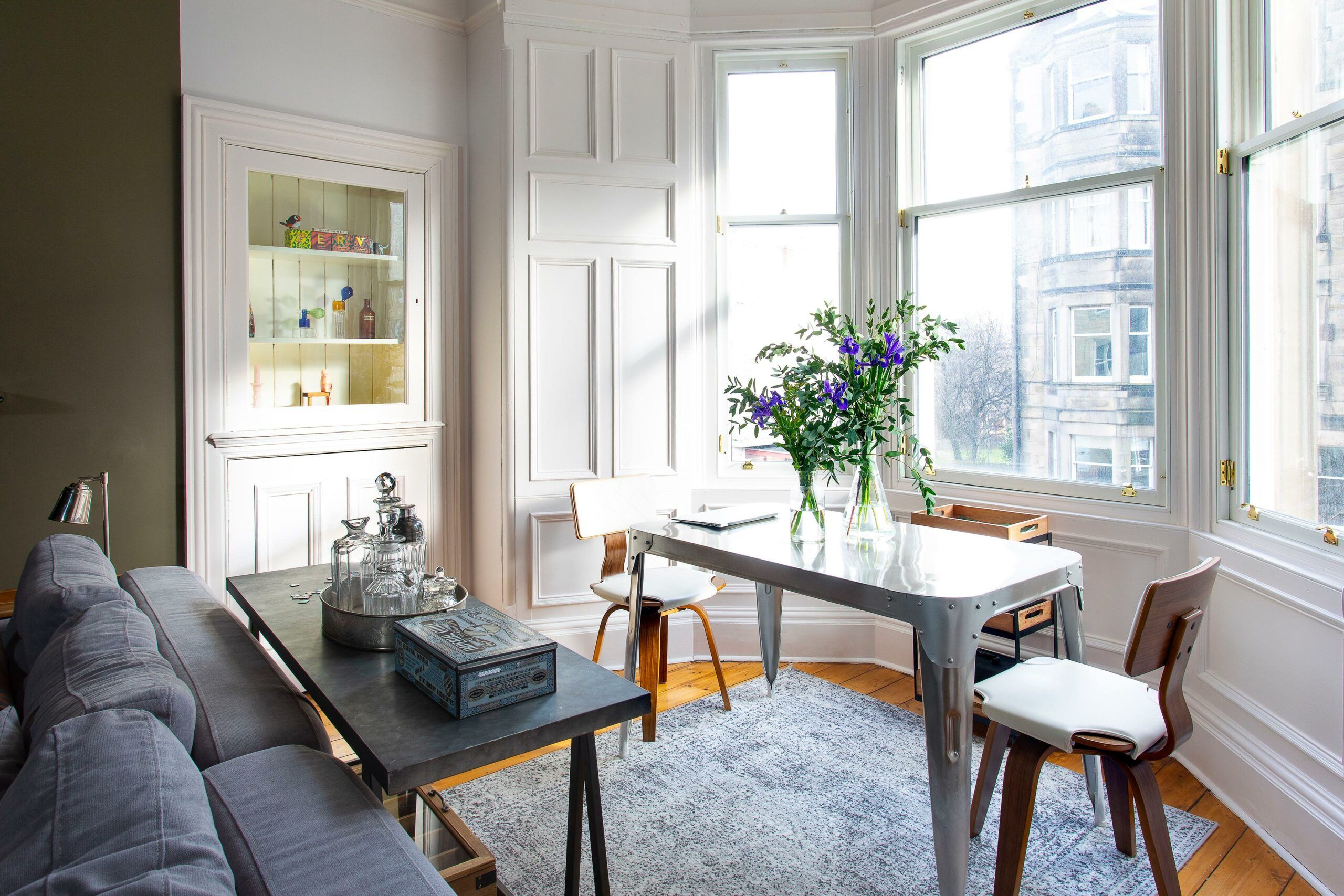 A small desk in a bay window area.