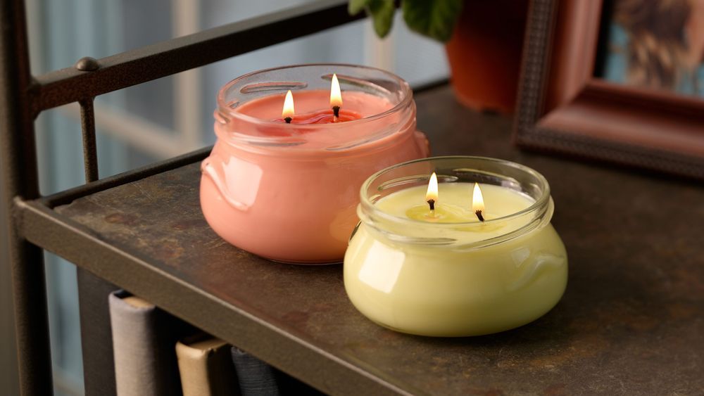 Candles on a bookshelf - lead image for best housewarming gifts