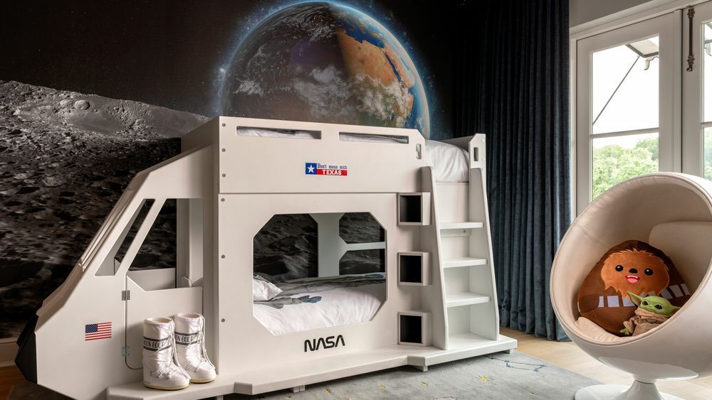 A space themed bunk bed in a kids' bedroom.