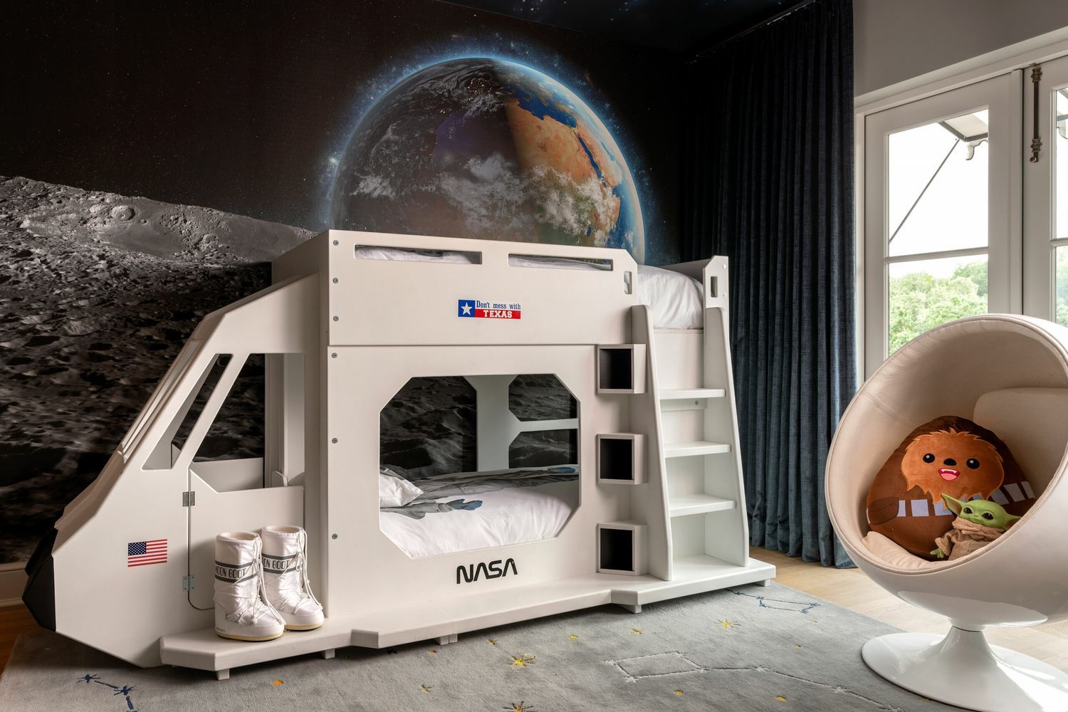 A space themed bunk bed in a kids' bedroom.