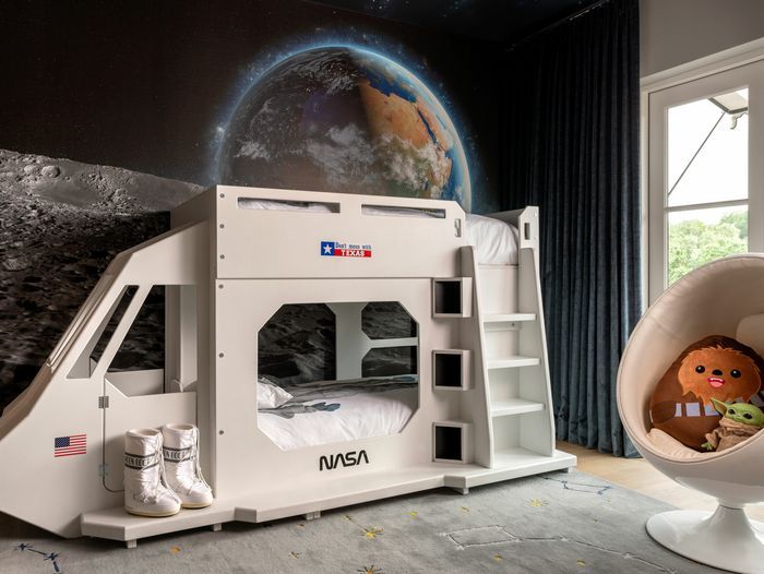A space themed bunk bed in a kids' bedroom.