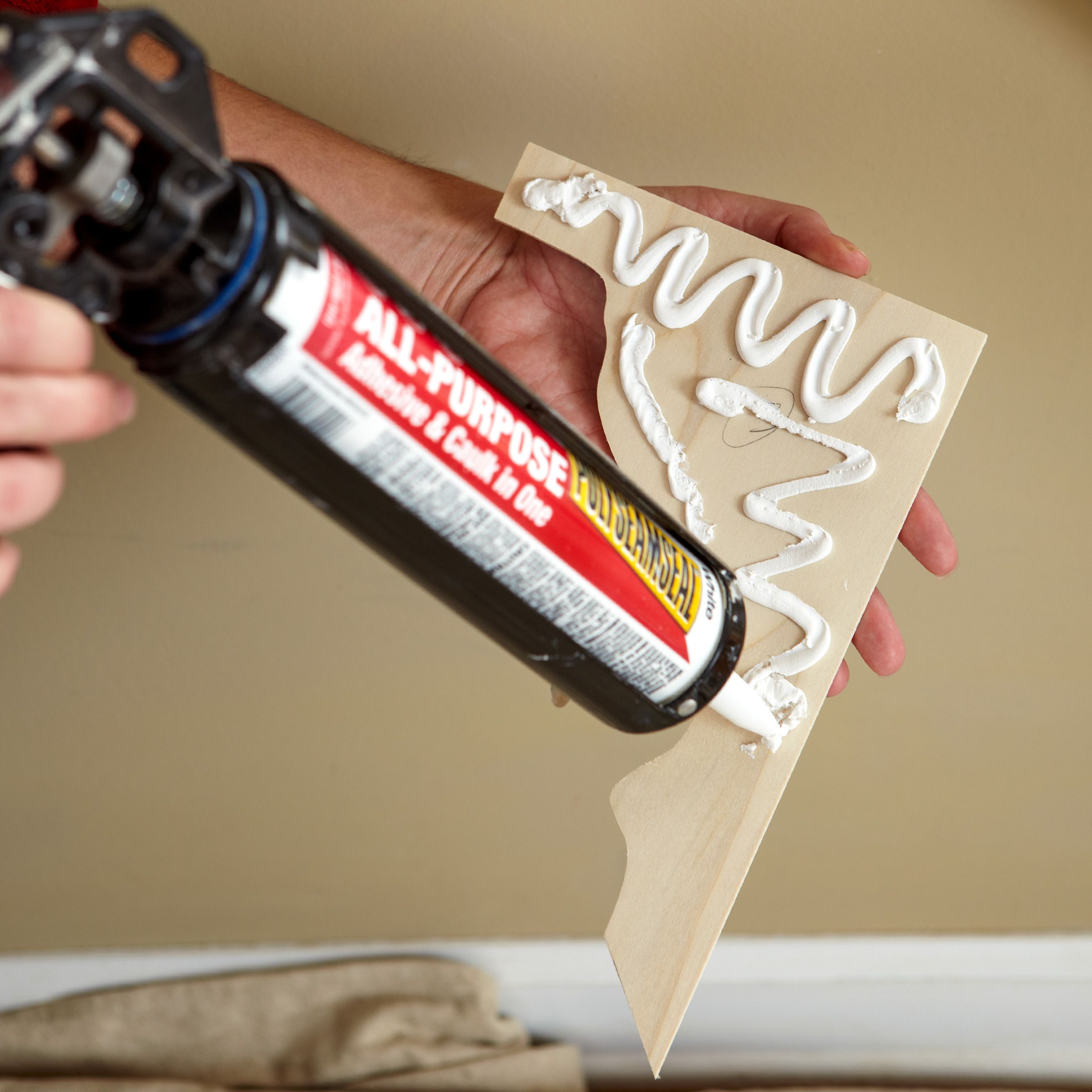 adding adhesive caulk to the back of a stair bracket