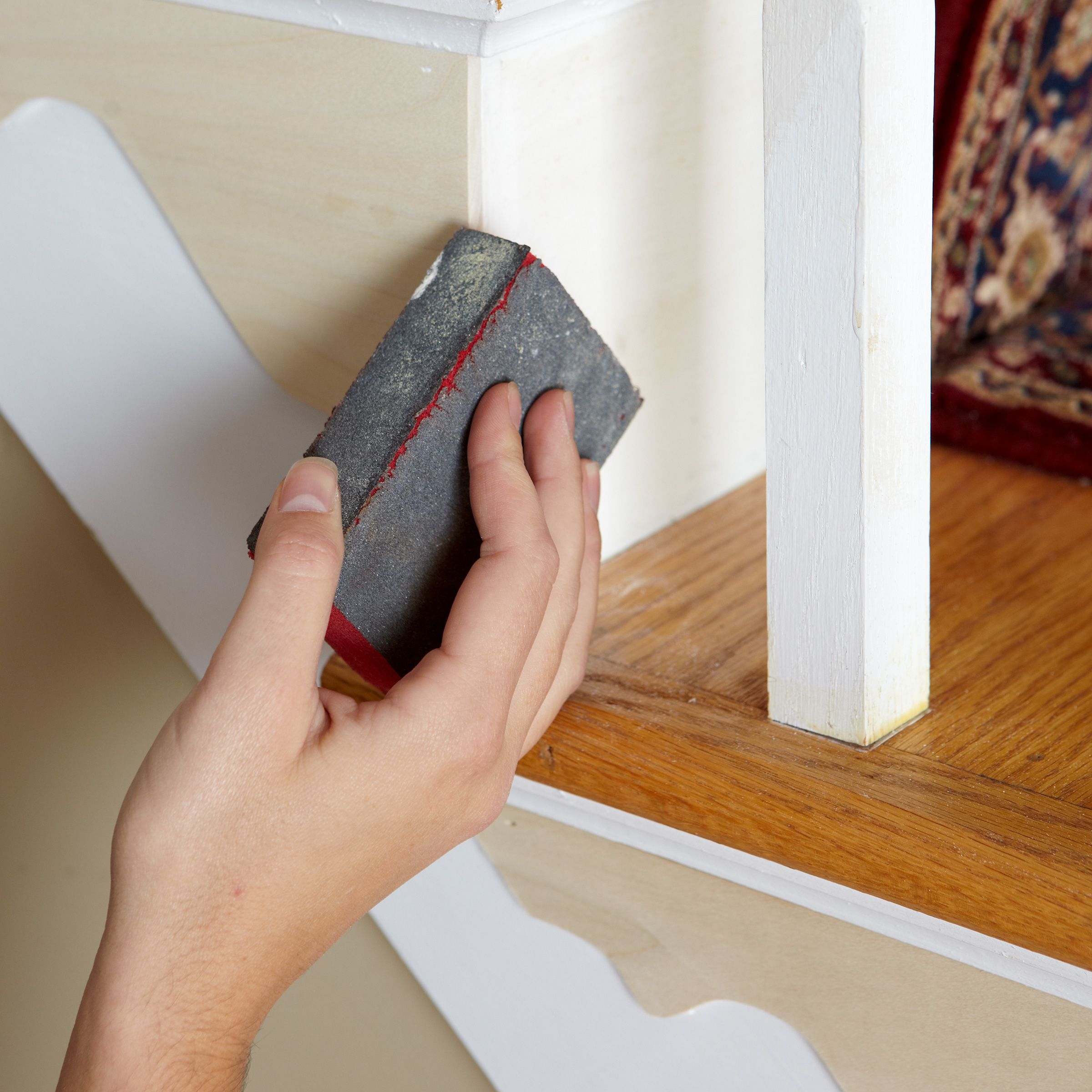 sanding the stair bracket for a smooth finish