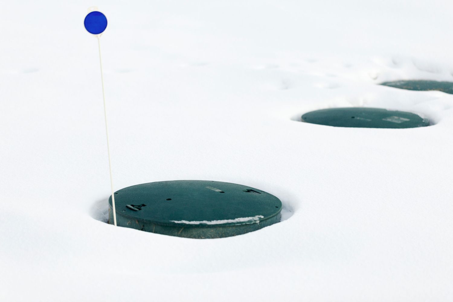 A frozen septic tank in the winter.
