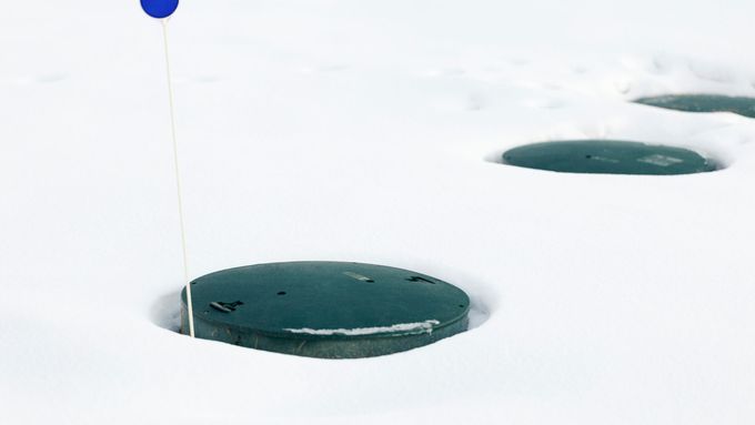 A frozen septic tank in the winter.