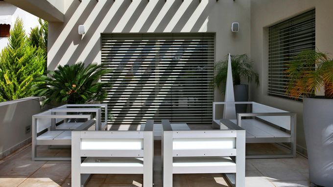 an outdoor patio with outdoor speakers that blend in