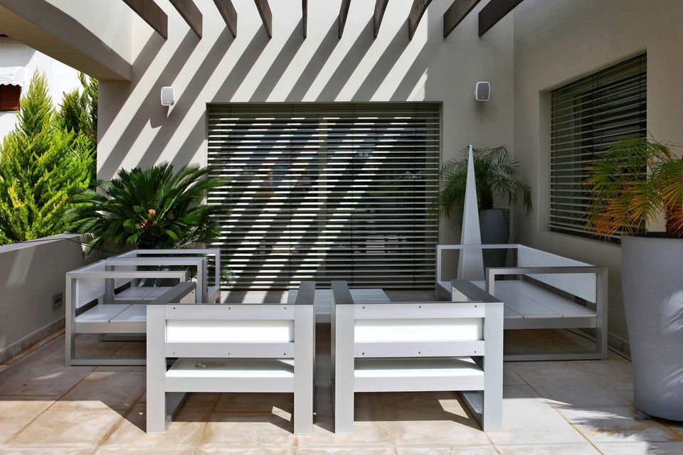 an outdoor patio with outdoor speakers that blend in