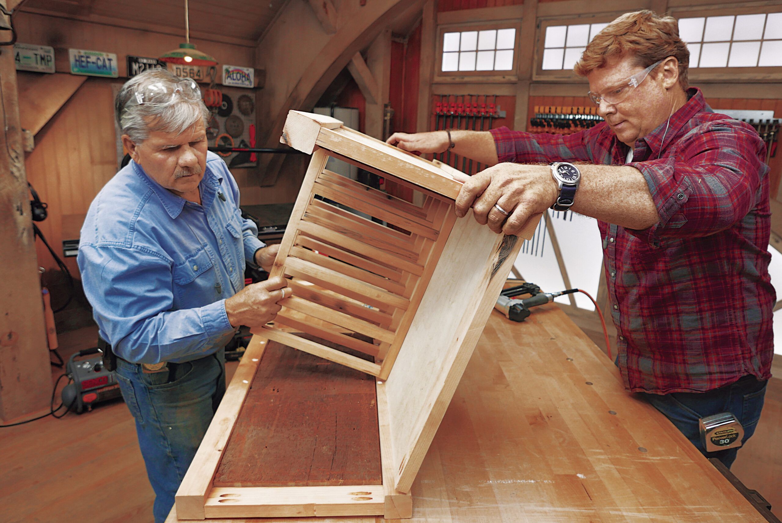 Tom Silva turning the cabinet assembly onto glued areas to finalize assembly. 