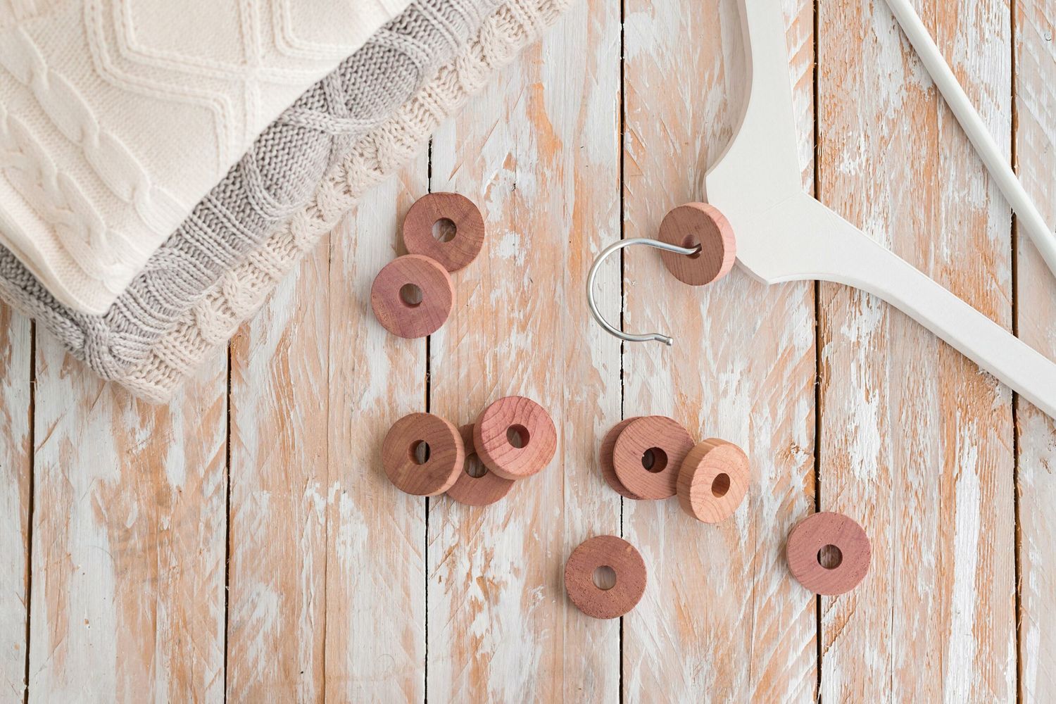 Wooden cedar rings for repelling moths and protect clothing in closets.